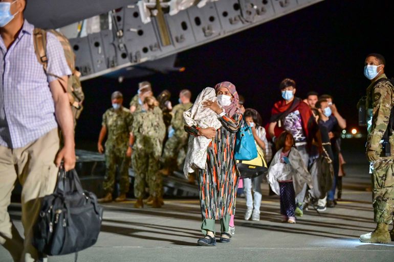 getty_698f583120-1771001905 NAVAL AIR STATION SIGONELLA, ITALY - AUGUST 22: In this handout image provided by U.S. Naval Forces Europe-Africa/U.S. Sixth Fleet, Afghan evacuees disembark a U.S. Air Force C-17 Globemaster III at Naval Air Station Sigonella on August 22, 2021. NAS Sigonella is currently supporting the Department of Defense mission to facilitate the safe departure and relocation of U.S. citizens, Special Immigration Visa recipients, and vulnerable Afghan populations from Afghanistan. (photo by U.S. Navy Petty Officer 1st Class Daniel Young via Getty Images)