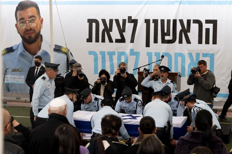 getty_6992a63835-1771218488 MEITAR, ISRAEL - JANUARY 28: Police officers carry a coffin with remains of Police officer Ran Guili during his funeral, after his body was recovered by Israeli soldiers from the Gaza Strip on January 28, 2026 in Meitar, Israel. Ran Gvili, a 24-year-old Israeli police officer, was killed defending Kibbutz Alumim against Hamas militants during the October 7, 2023 attack. His body was taken to Gaza, where he remained the last of the 251 hostages captured and held in the territory. On Monday the Israeli military announced it had identified and retrieved Gvili's remains, 843 days following the Hamas attack on Israel. Gvili's return marks a significant moment as the Gaza ceasefire moves into its second phase. (Photo by Amir Levy/Getty Images)