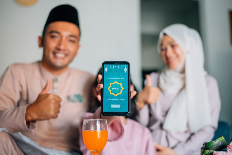 An Asian Malay family using e-wallet as Money Packet during Hari Raya