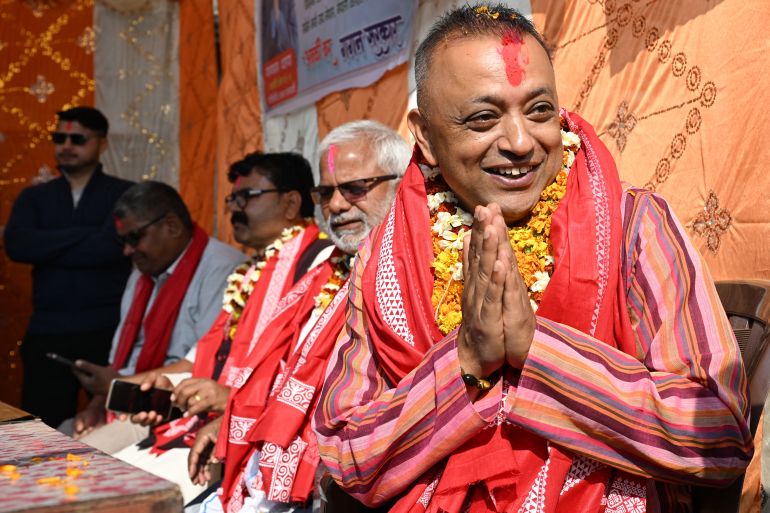 ind1-1772179729 Nepali Congress party's president and election candidate Gagan Thapa (R) greets supporters during a door-to-door campaign in Sarlahhi on February 21, 2026. (Photo by PRAKASH MATHEMA / AFP)