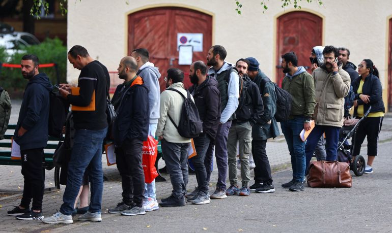 Migrants queue in a waiting area to be escorted to a registration office at the arrival centre for asylum seekers in Reinickendorf district, Berlin, Germany, October 6, 2023. REUTERS/Fabrizio Bensch