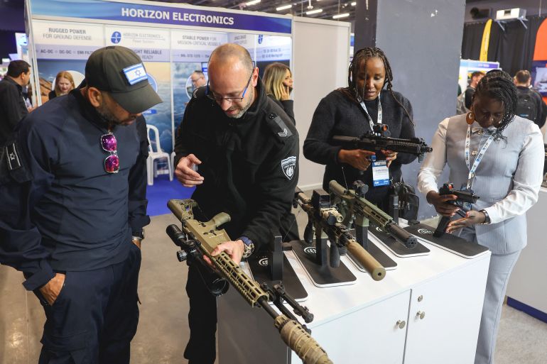 pic-88742-1772040336 Visitors (R) look at firearms from the EMTAN (Israel Small Arms Industry) company during the Defense Tech Expo exhibition in Tel Aviv on February 17, 2026. (Photo by JACK GUEZ / AFP)