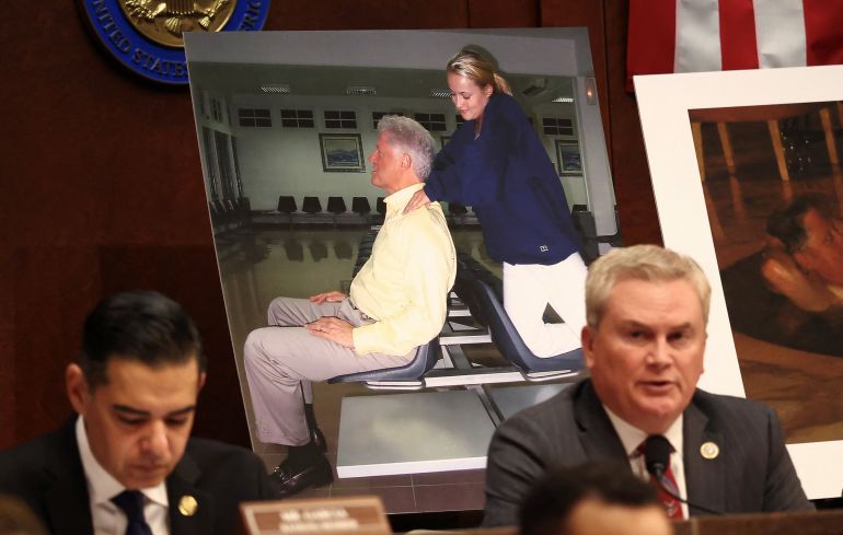 Images of former U.S. President Bill Clinton are on display as Chairman of the House Oversight Committee James Comer (R-KY) speaks during a meeting to vote on whether to hold Clinton and former Secretary of State Hillary Clinton in contempt of Congress for defying subpoenas to testify in the panel's investigation of the late convicted sex offender Jeffrey Epstein, on Capitol Hill in Washington, D.C., U.S., January 21, 2026. REUTERS/Kevin Lamarque