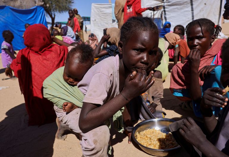 reuters_69852780-1770334081 FILE PHOTO: Sudanese refugee children from Al-Fashir share a meal from a single plate at the Tine transit refugee camp, amid the conflict between the paramilitary Rapid Support Forces (RSF) and the Sudanese army, in eastern Chad, November 22, 2025. REUTERS/Amr Abdallah Dalsh/File Photo