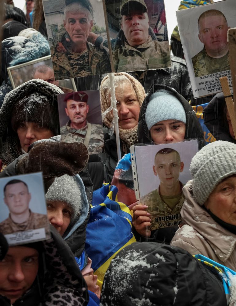 reuters_6985515d-1770344797 People hold portraits of their relatives, Ukrainian prisoners of war (POWs), hoping they will be recognized by returning prisoners of war after a swap, amid Russia's attack on Ukraine, at an undisclosed location, in Ukraine, February 5, 2026. REUTERS/Anatolii Stepanov