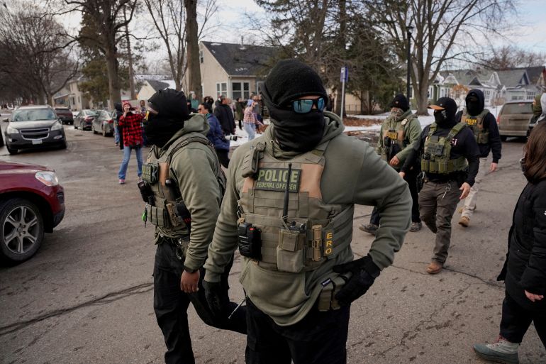 FILE PHOTO: Community members react to federal immigration agents conducting immigration enforcement tasks in Minneapolis, Minnesota, U.S., February 5, 2026. REUTERS/Seth Herald/File Photo