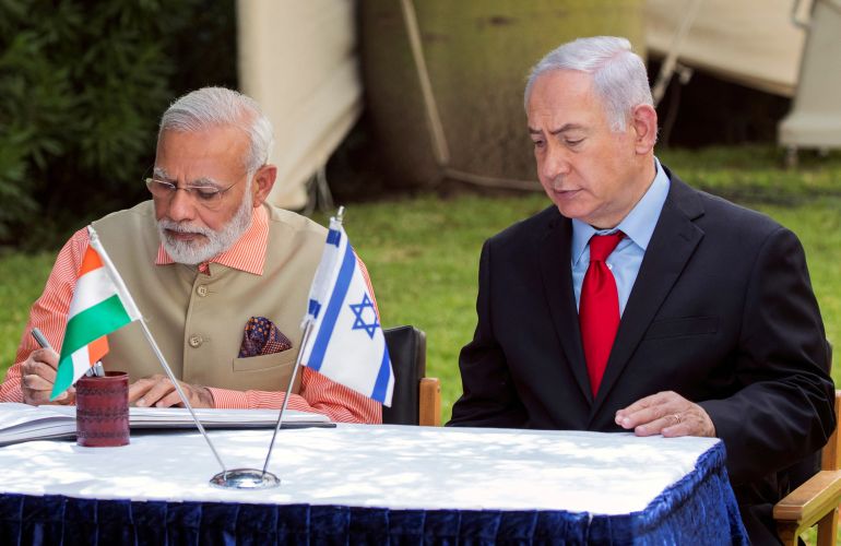 reuters_699e99a4-1772001700 FILE PHOTO: Indian Prime Minister Narendra Modi (L) and Israeli Prime Minister Benjamin Netanyahu (R) sign the guest book at the Indian Army Cemetery of World War I to honour fallen Indian soldiers, in the Israeli coastal city of Haifa July 6, 2017. REUTERS/Jack Guez/Pool/File Photo