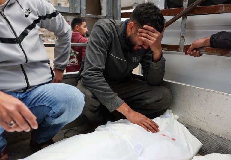 A mourner reacts as he leans over the body of one of two Palestinians killed by an Israeli strike on Thursday, according to medics, during their funeral at Shifa hospital in Gaza City, February 26, 2026. REUTERS/Dawoud Abu Alkas