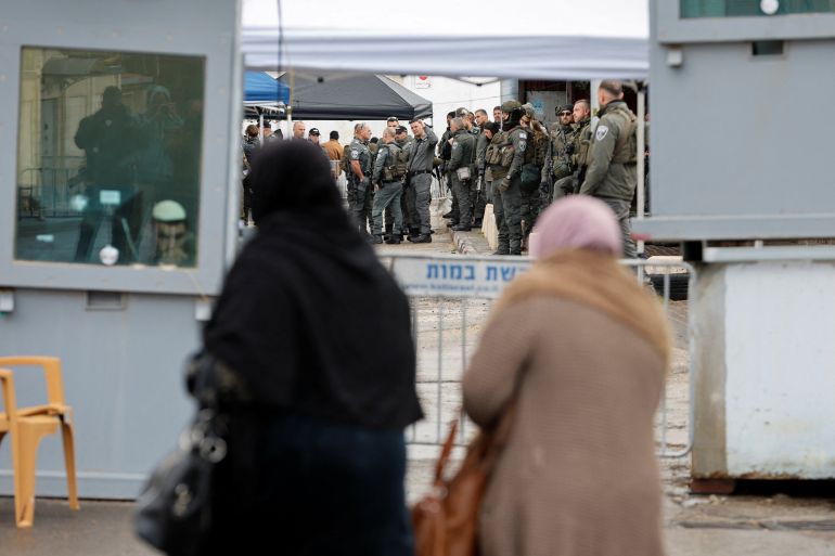 Members of the Israeli security forces gather at an Israeli checkpoint, as Palestinians make their way to the Al-Aqsa compound, also known to Jews as Temple Mount, in Jerusalem's Old City, to attend Friday prayers during the Muslim holy fasting month of Ramadan, in Bethlehem in the Israeli-occupied West Bank, February 27, 2026. REUTERS/Mussa Qawasma
