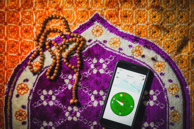 Kuching, Malaysia - May 2019 - Flatlay concept for Muslim Pro icon apps for muslim. Very popular apps for reading quran, performing pray or "solah" and qibla direction. Best islamic apps in 2019