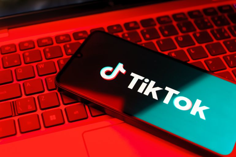 Prague, Czechia - 7 20 2024: Smartphone on surface showing TikTok logo.