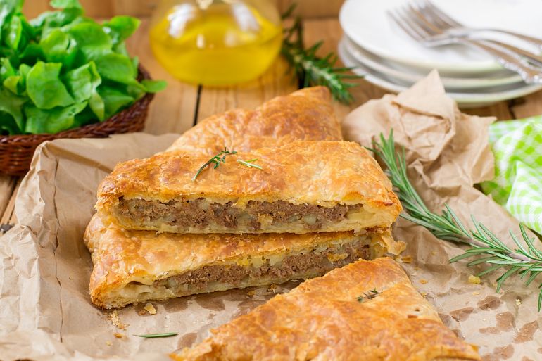 Meat pie with puff pastry, minced beef, onions and potatoes