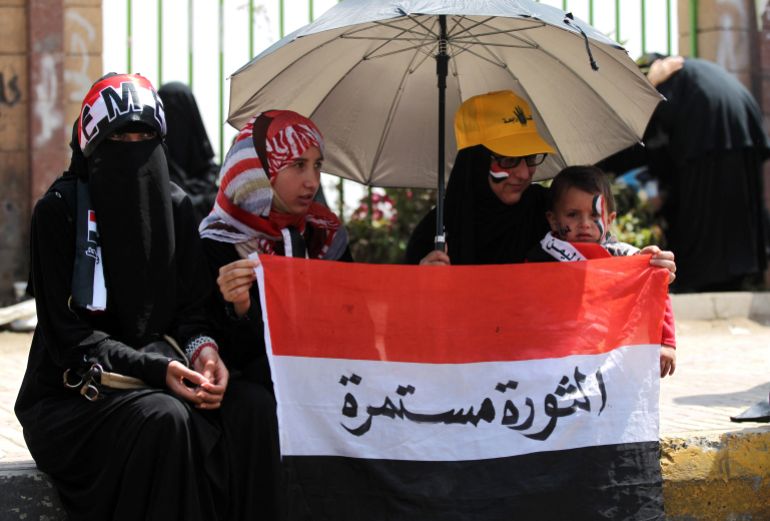 yemeni-protesters-1-1770030343 Yemeni protesters hold their national flag as they take part in a demonstration to demand that the government to achieve the political and economic goals of the revolution that broke out in 2011, on February 21, 2014 in Sanaa. Yemeni forces shot dead one protester and wounded 16 others as they opened fire on defiant secessionist demonstrators in the southern city of Aden, hours after killing another. AFP PHOTO/ MOHAMMED HUWAIS (Photo by MOHAMMED HUWAIS / AFP)