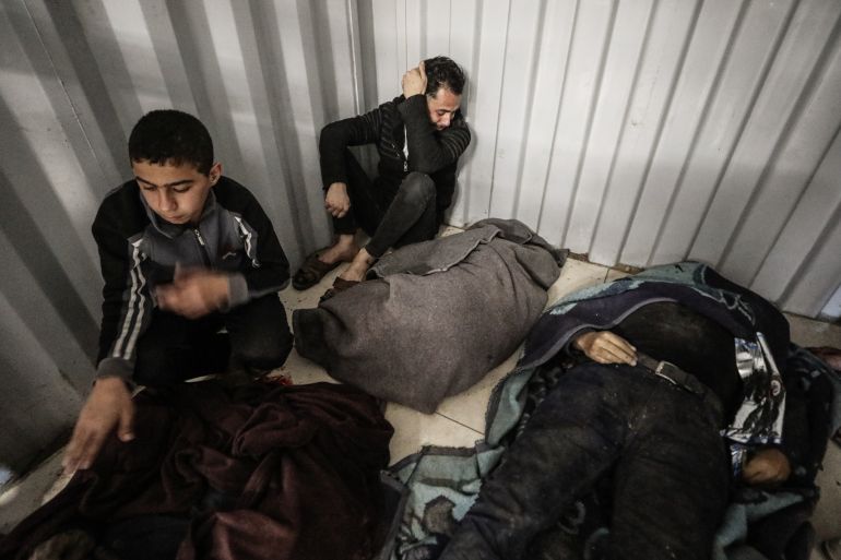 GAZA CITY, GAZA - MARCH 22: (EDITOR'S NOTE: Image depicts death) Bodies of four people who lost their lives in an Israeli airstrike targeting a police vehicle in the Nuseirat Refugee Camp are brought to Al-Awda Hospital, as eight others are injured and relatives mourn, in Gaza City, Gaza, on March 22, 2026. (Photo by Moiz Salhi/Anadolu via Getty Images)