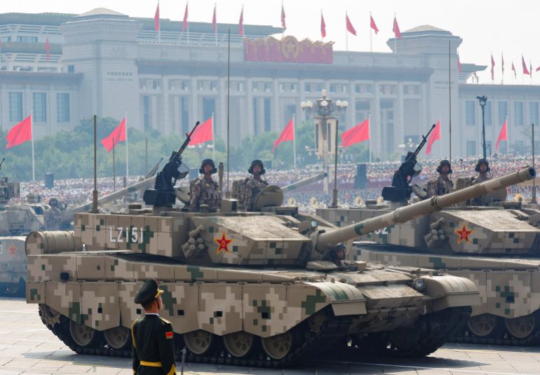 Members of the People's Liberation Army stand as the land operations group displays tanks during a military parade to mark the 80th anniversary of the end of World War Two, in Beijing, China, September 3, 2025. REUTERS/Maxim Shemetov