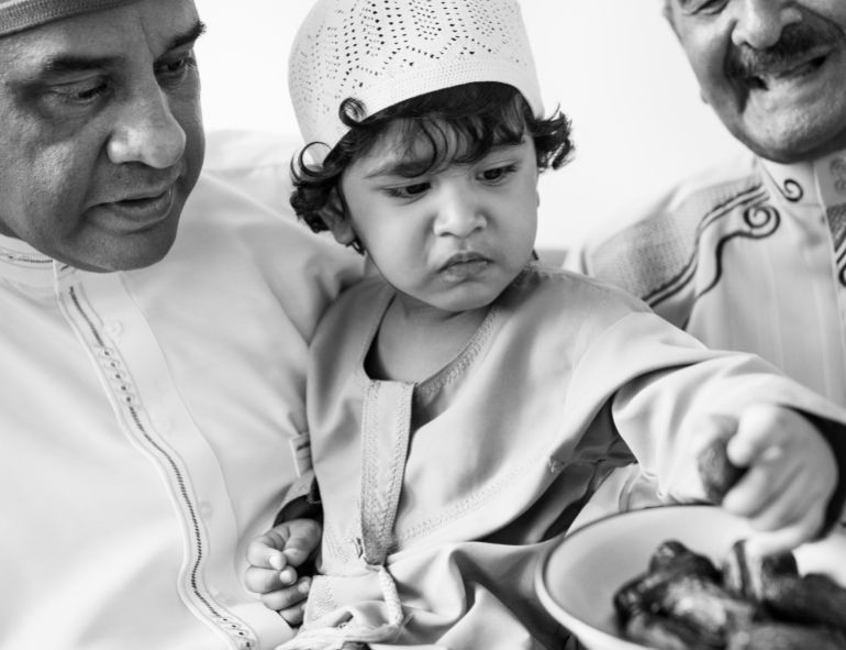 Muslim boy eating dried dates فري بيك