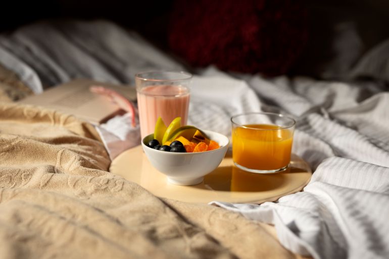 Close up on romantic breakfast in bed arrangement freepik