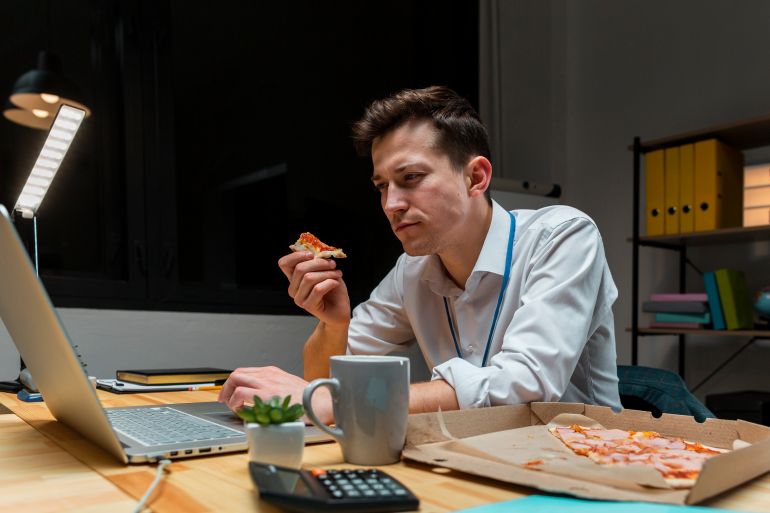 Portrait of male having a snack while working from home freepik