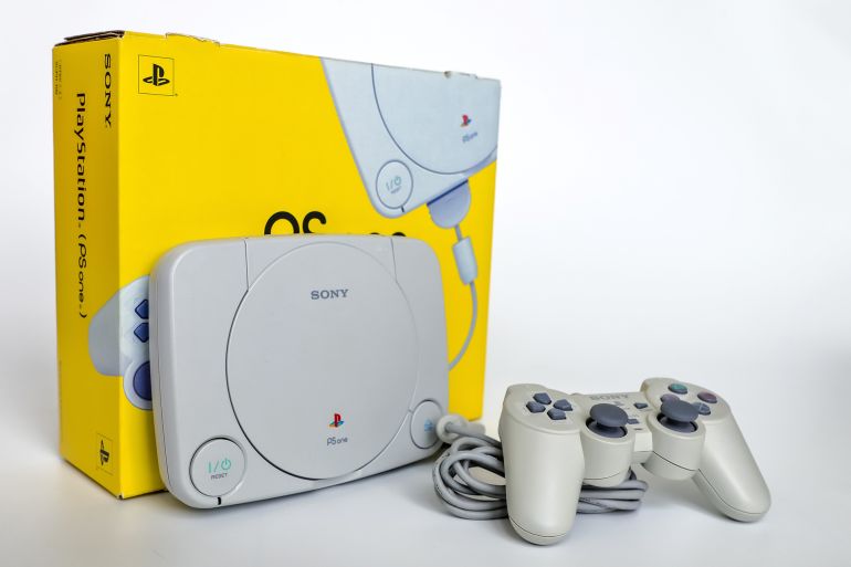 Bangkok, Thailand - May 22, 2022 : The paper box with PS One model redesigned version smaller of the original PlayStation 1 home gaming console with wired Dual shock Analog Play station controller.