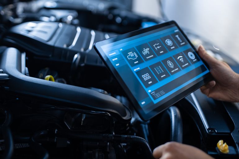 54tgdf-1774020851 Car Service Manager or Mechanic Uses a Tablet Computer with a Futuristic Interactive Diagnostics Software. Specialist Inspecting the Vehicle by Gorodenkoff @ادوبي ستوك