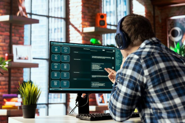 54ytfd-1774604921 Person listening music uses large language model generative AI chatbot engaging in humanlike interactions. Man wearing headphones solves tasks with artificial intelligence LLM handling user requests