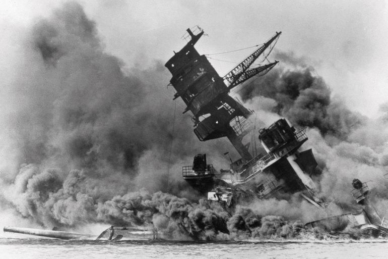 In this Dec. 7, 1941 file photo, smoke rises from the battleship USS Arizona as it sinks during the Japanese attack on Pearl Harbor, Hawaii. About 20 survivors are gathering on Friday, Dec. 7, 2018 at Pearl Harbor to remember thousands of men lost in the Japanese attack 77 years ago. The youngest of the survivors is in his mid-90s. The Navy and National Park Service will jointly host the remembrance ceremony Friday at a grassy site overlooking the water and the USS Arizona Memorial. (AP Photo, File)