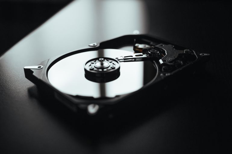 Opened hard drive from the computer hdd with mirror effects. Part of computer pc, laptopDisassembled hard drive from the computer, hdd with mirror effect. Opened hard drive from the computer hdd with mirror effects. Part of computer pc, laptop