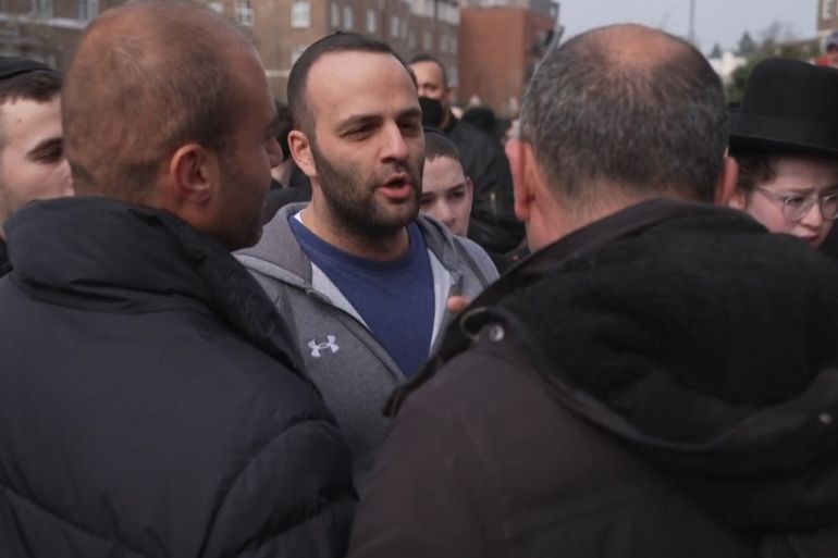 Al Jazeera camera crew told to 'go home' at scene of Jewish ambulance arson attack @لقطة شاشة من رويترز