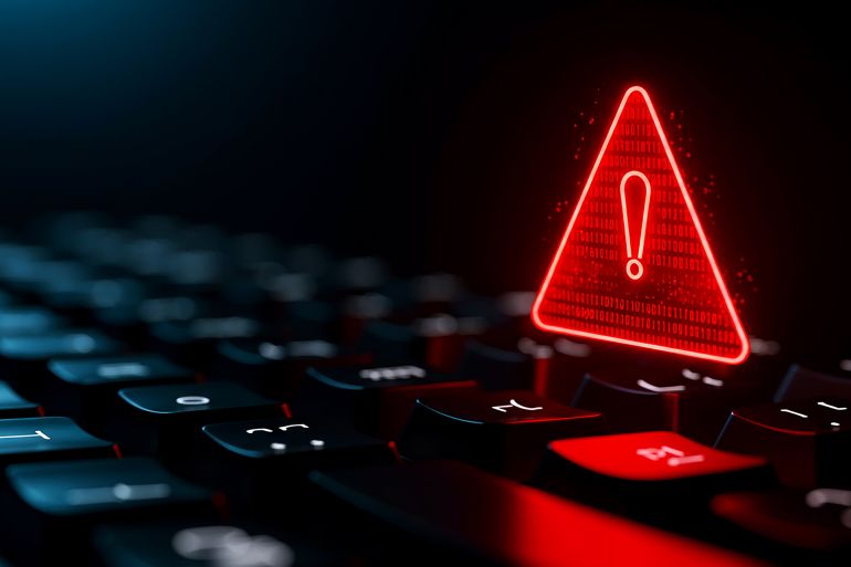 5trfg-1772459114 A glowing red warning triangle hovers over a keyboard, signaling a cyber attack. The dramatic lighting enhances the sense of urgent danger.