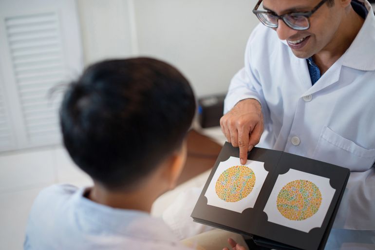 Indian optometrist or optician get color blindness tested for indian child boy, vision and eye care concept by chomplearn_2001 @ادوبي ستوك