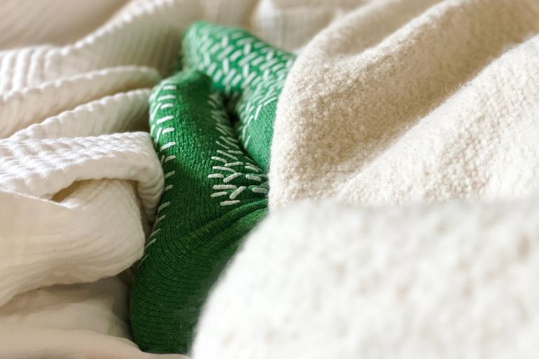 female resting while wearing hospital socks with safety grips to prevent falls