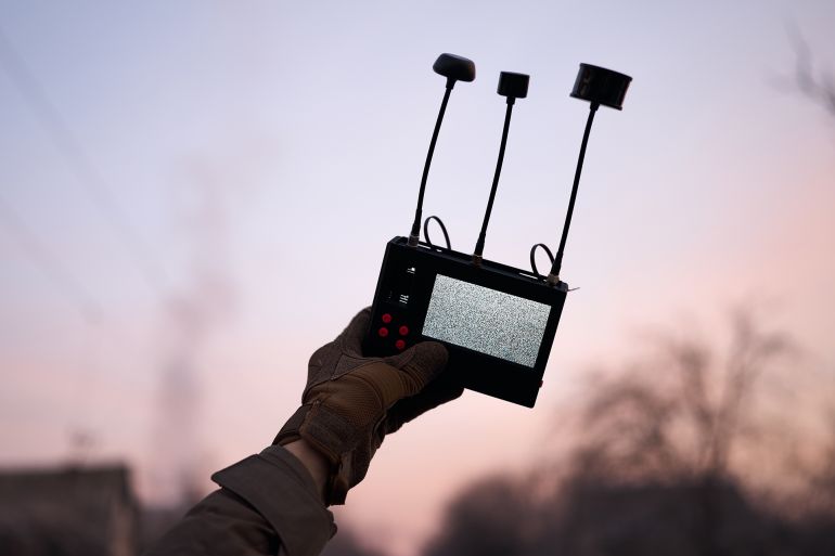 6d8bad981d984d8a7-1772970860 KOSTIANTYNIVKA DISTRICT, UKRAINE - FEBRUARY 11: A Ukrainian serviceman monitors the sky using a handheld drone detection device designed to identify the presence and signal activity of nearby FPV attack drones, scanning for potential aerial threats while stationed near the road between Kostiantynivka and Druzhkivka in the Donetsk region amid ongoing combat operations on February 11, 2026 in Kostiantynivka District, Ukraine. (Photo by Kostiantyn Liberov/Libkos/Getty Images)