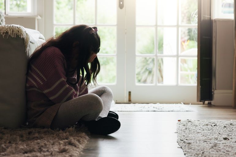 6ryhg6-1772982415 Sad, child and crying on floor in home with mental health, abuse or anxiety from trauma. Crisis, unhappy and girl kid with depression from loneliness, bullying victim or emotional burnout from stress