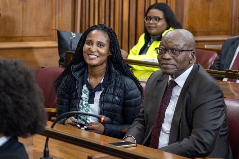 (FILES) Former South African President Jacob Zuma (R) and his daughter, Duduzile Zuma (L), look on as they wait in court ahead of the private prosecution trial, where Zuma is suing South African President Cyril Ramaphosa over a leaked medical report linked to a 1990s arms corruption trial, in Johannesburg on April 11, 2024.