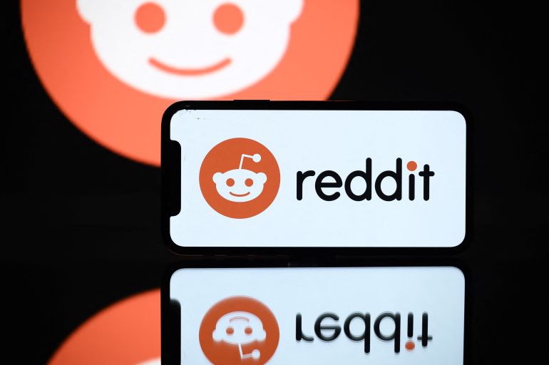 (FILES) A picture taken on October 5, 2021 in Toulouse shows the logo of Reddit social media displayed by a by a tablet and a smartphone.