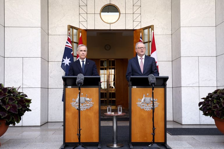 Canada's Prime Minister Mark Carney (L) stands with Australia's Prime Minister Anthony Albanese during a press conference at Parliament House in Canberra on March 5, 2026. (Photo by DAVID GRAY / AFP)