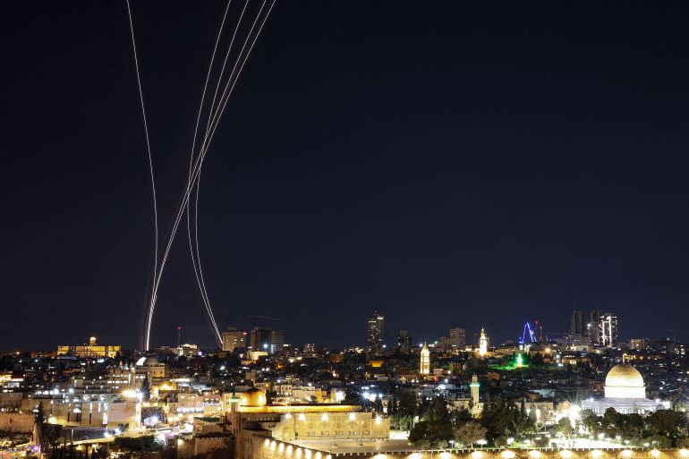TOPSHOT - Rocket trails from an interception by Israel's Iron Dome missile defence system are pictured over Jerusalem on March 1, 2026.
