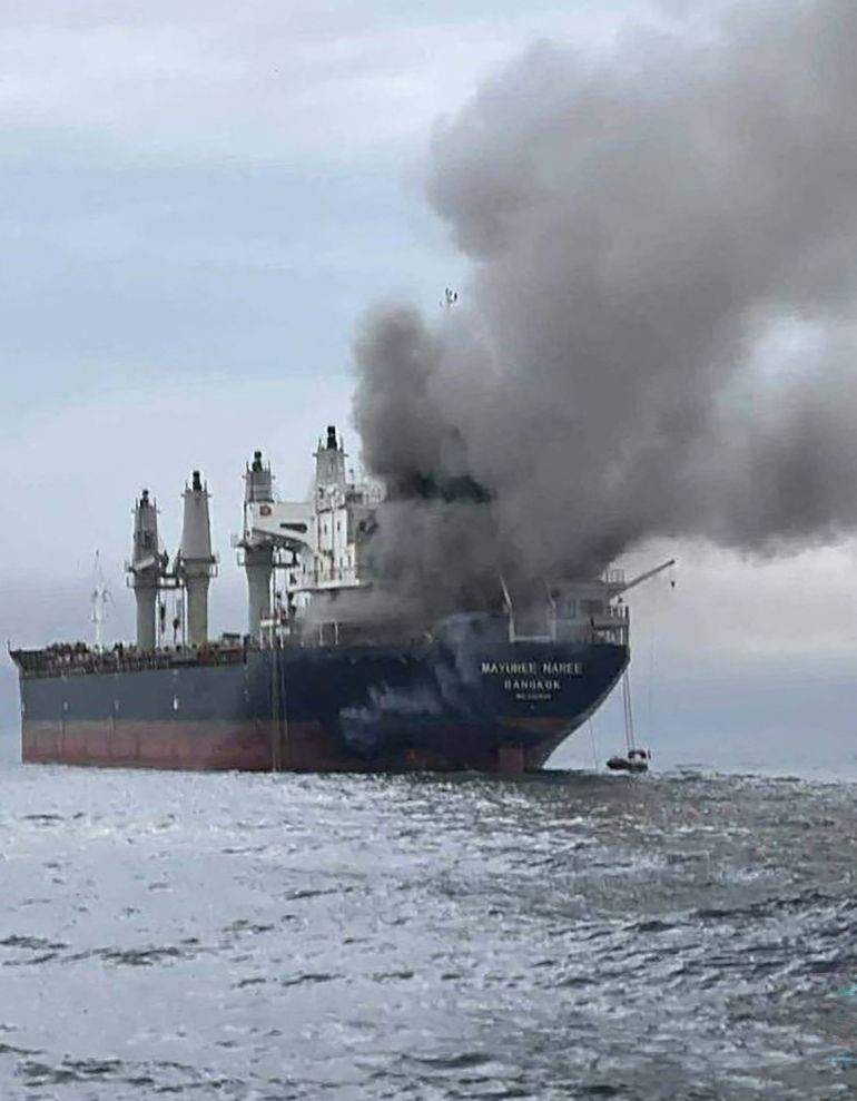 This handout photo taken on March 11, 2026 and released by the Royal Thai Navy shows smoke rising from the Thai bulk carrier 'Mayuree Naree' near the Strait of Hormuz after an attack.