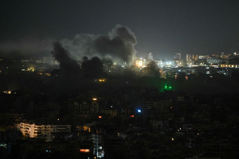 A plume of smoke rises from the site of an Israeli airstrike in the southern suburbs of Beirut early on March 12, 2026.
