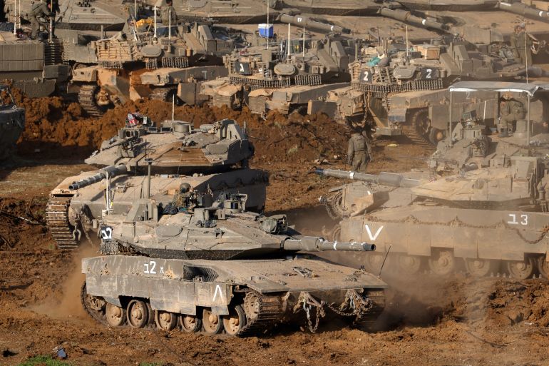 afp_69b312832ba4-1773343363-2 Israeli army tanks deploy at a position in the Upper Galilee in northern Israel near the border with Lebanon on March 12, 2026.