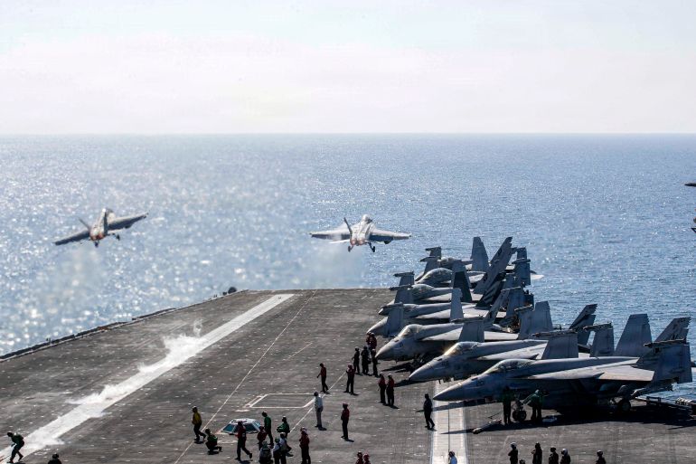 TOPSHOT - This US Navy handout photo released by US Central Command public affairs shows two F/A-18 Super Hornets launching from the flight deck of Nimitz-class aircraft carrier USS Abraham Lincoln (CVN 72) in support of Operation Epic Fury on March 3, 2026.
