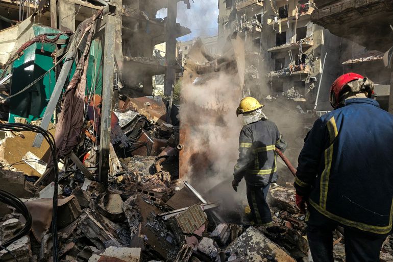 Firefighters work at the site of overnight Israeli airstrikes in the southern suburbs of Beirut on March 16, 2026.