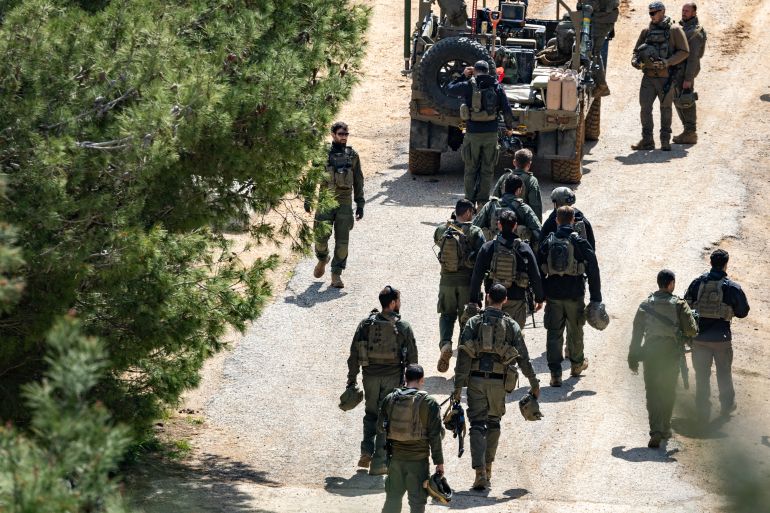 Israeli army soldiers gather on the border with Lebanon in the Upper Galilee, northern Israel on March 16, 2026.