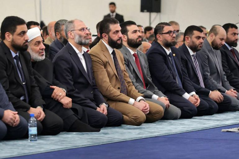 This handout photograph released by the official Syrian Arab News Agency (SANA) shows Syria's interim president Ahmed al-Sharaa (C) attending the early morning prayers for Eid al-Fitr, marking the end of the holy month of Ramadan, in Damascus on March 20, 2026. (Photo by SANA / AFP) / RESTRICTED TO EDITORIAL USE - MANDATORY CREDIT "AFP PHOTO / SANA" - HANDOUT - NO MARKETING NO ADVERTISING CAMPAIGNS - DISTRIBUTED AS A SERVICE TO CLIENTS
