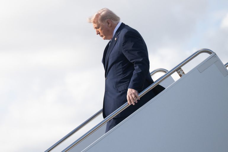 afp_69bdd1f397b7-1774047731 US President Donald Trump disembarks Air Force One at Palm Beach International Airport in West Palm Beach, Florida, on March 20, 2026, en route to his Mar-a-Lago resort.