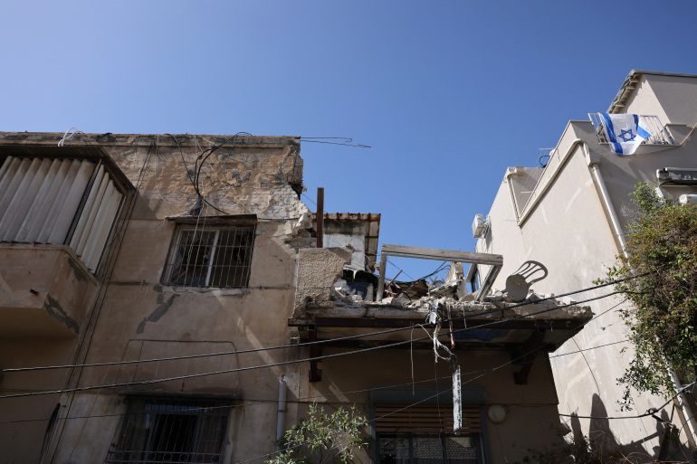 A view of a damaged house following an impact reportedly caused either by a missile or by interceptor fragments in Tel Aviv on March 22, 2026.