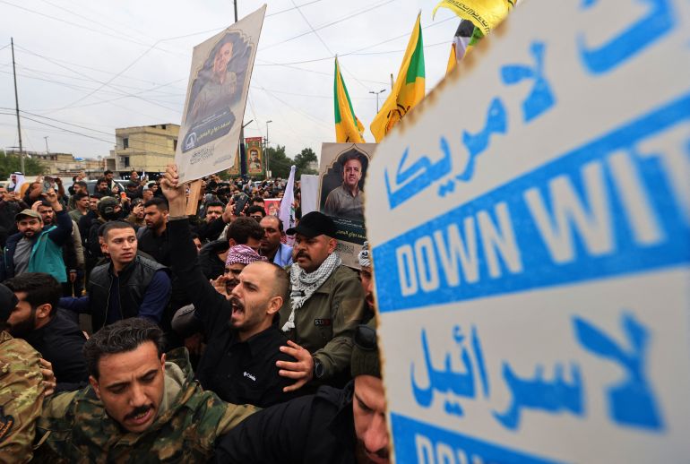 Members of Iraq's Hashed al-Shaabi, an alliance of factions now integrated into the regular army, take part during the funeral of the Hashd al-Shaabi operations commander for Al-Anbar, Saad Dawai in Baghdad on March 24, 2026.