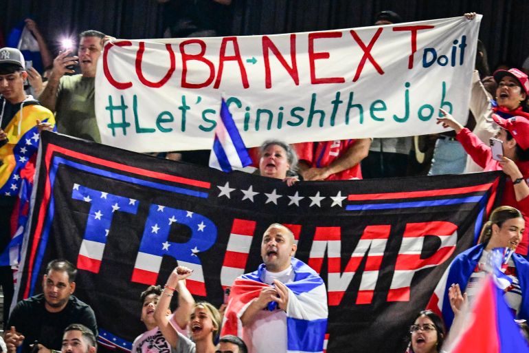 afp_69c3ddd9acda-1774443993 People hold Cuban flags and a flag supporting US President Donald Trump while participating in the "Cuba Libre" demonstration in the city of Hialeah, Florida, on March 24, 2026. (Photo by GIORGIO VIERA / AFP)