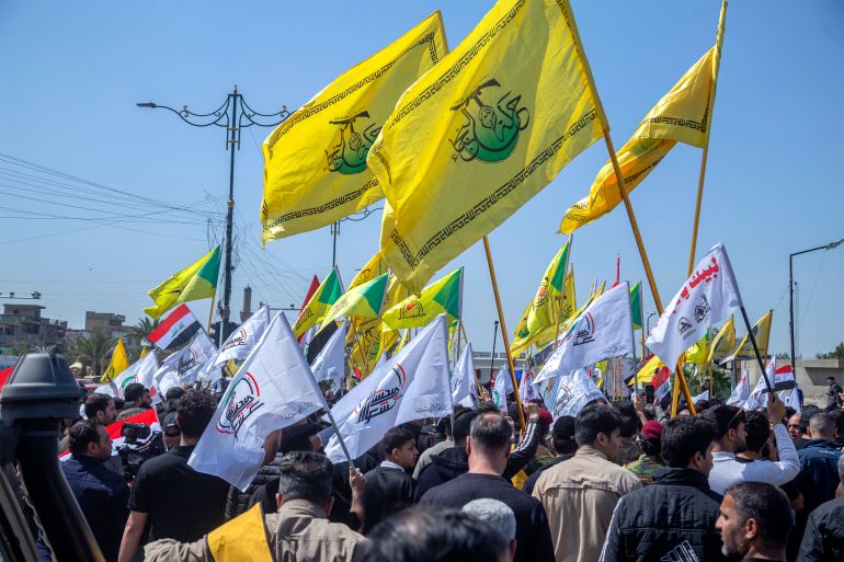 Mourners march in the funeral of Hussein Fadhel Ali, a member of Iraq's Hashed al-Shaabi alliance now integrated into the regular army but which also includes brigades belonging to Iran-backed groups, who was killed in a strike earlier in the week, in Baghdad's Sadr City suburb on March 24, 2026.