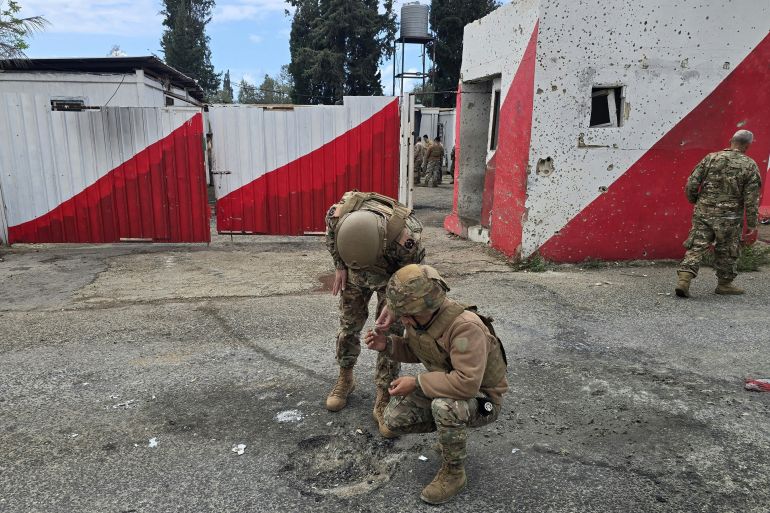 afp_69ca83b8723a-1774879672 Lebanese army soldiers inspect the site of an Israeli airstrike that targeted their checkpoint in Aamriyeh, south of the coastal city of Tyre, on March 30, 2026.